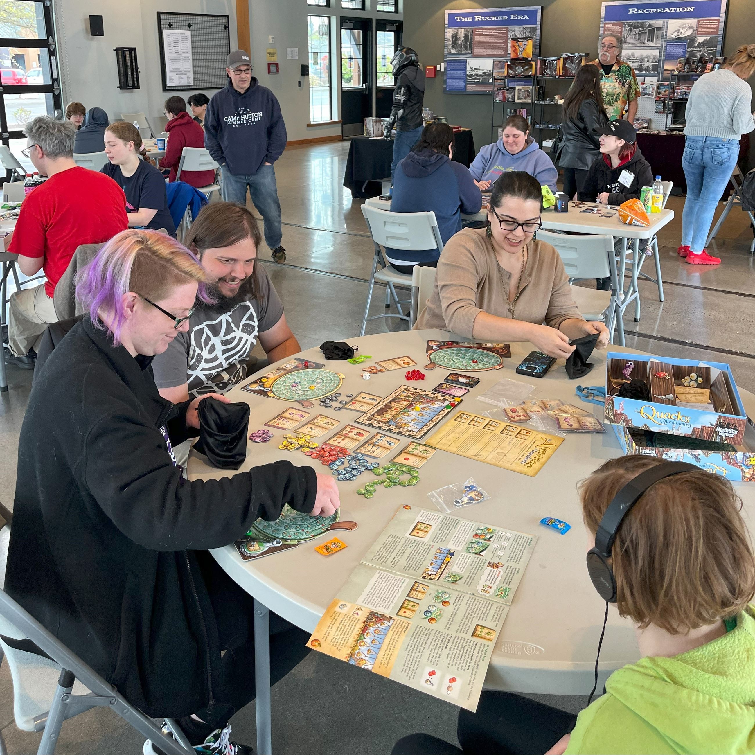 Various groups playing table games for a community event